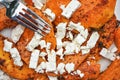 Fork over bright orange grilled butternut squash and white feta cheese Royalty Free Stock Photo
