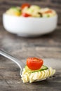 Fork with pasta salad on rustic wooden table Royalty Free Stock Photo