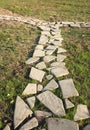 Fork on path in a park, paved with flat gray stones