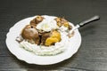 Fork with a portion of Profiterole with whipped cream. Royalty Free Stock Photo