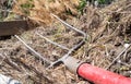 Fork with red handle for composting, recycling lawn and garden waste. Forks stuck in compost. Making and mixing compost in the Royalty Free Stock Photo