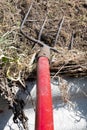 Fork with red handle for composting, recycling lawn and garden waste. Forks stuck in compost. Making and mixing compost in the Royalty Free Stock Photo