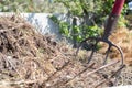 Fork with red handle for composting, recycling lawn and garden waste. Forks stuck in compost. Making and mixing compost in the Royalty Free Stock Photo