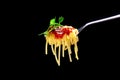 A fork with rolled spaghetti, tomato sauce and basil. Italian pasta Royalty Free Stock Photo