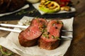 Fork with slices of grilled meat on table Royalty Free Stock Photo