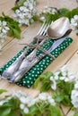 Fork, spoon and knife lying on a wooden background among the bra Royalty Free Stock Photo