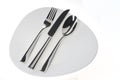 Fork, spoon and knife on a plate over white Royalty Free Stock Photo