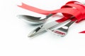 Fork, spoon and knife tied up with red ribbon Royalty Free Stock Photo