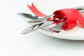 Fork, spoon and knife tied up with red ribbon Royalty Free Stock Photo