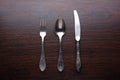 Fork, spoon and knife on wooden table
