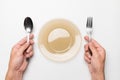 fork and spoon in male hands at an empty plate in anticipation, a hungry client, white isolated background Royalty Free Stock Photo