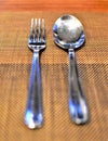 A fork and a spoon silverware arranged neatly