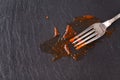 Fork stained tomato ketchup on slate table