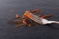 Fork stained tomato ketchup on slate table