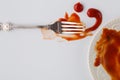 Fork stained tomato ketshup on table with dish