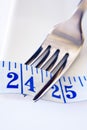 Fork and Tape Measure Showing 24 Inches Royalty Free Stock Photo