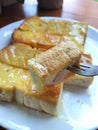 fork with toasted bread with butter and condensed milk Royalty Free Stock Photo