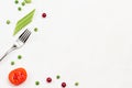 Fork, tomato, cranberry and celery stems on white background