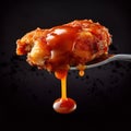 Fork with tomato sauce. Boneless chicken piece with sauce in a fork.