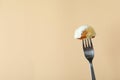 Fork with varenik or pierog on beige background Royalty Free Stock Photo