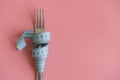 fork wrapped in tape measure on pink background. Proper nutrition. Medical starvation. Diet for weight loss concept. Free space Royalty Free Stock Photo