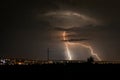 Forked lightning bolts strike down to earth near the city of Targu Mures, Romania. Royalty Free Stock Photo