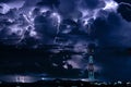 Forked lightning over the cell phone antenna tower at night Royalty Free Stock Photo