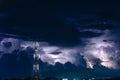 Forked lightning over the cell phone antenna tower at night Royalty Free Stock Photo