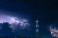 Forked lightning over the cell phone antenna tower at night Royalty Free Stock Photo