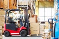 Forklif with a three large cardboard boxes in a modern warehous Royalty Free Stock Photo
