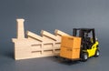 Forklift carries cardboard boxes and building a factory or plant. Services transportation of goods products, logistics