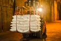 Forklift carries jumbo bag of refine white sugar to put on the stack inside warehouse. Sugar warehouse operations and management. Royalty Free Stock Photo