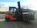 Forklift carrying plastic drain pipes pvc Royalty Free Stock Photo