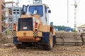 A forklift at a construction site is lifting a reinforced concrete slab. Construction machine. Industry