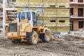 A forklift at a construction site is lifting a reinforced concrete slab. Construction machine. Industry