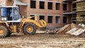 A forklift at a construction site is lifting a reinforced concrete slab. Construction machine. Industry