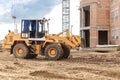 A forklift at a construction site is lifting a reinforced concrete slab. Construction machine. Industry. Construction machinery