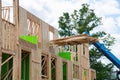 forklift at a construction site of a plywood house wood new frame up Royalty Free Stock Photo