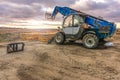 Forklift on a construction site, preparing to raise construction parts Royalty Free Stock Photo