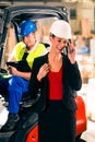 Forklift driver and supervisor at warehouse Royalty Free Stock Photo