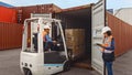 Forklift Driver Loading a Shipping Cargo Container with a Full Pallet with Boxes in Logistics Port Royalty Free Stock Photo