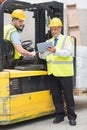 Forklift driver talking with his manager Royalty Free Stock Photo