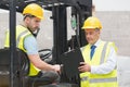 Forklift driver talking with his manager Royalty Free Stock Photo