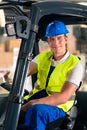 Forklift driver at warehouse of forwarding