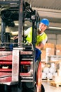 Forklift driver at warehouse of forwarding