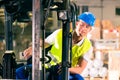 Forklift driver at warehouse of forwarding Royalty Free Stock Photo