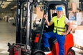 Forklift driver at warehouse of forwarding Royalty Free Stock Photo
