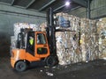 Forklift grabbing paper bales