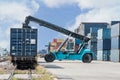 Forklift handling container box loading to freight train Royalty Free Stock Photo