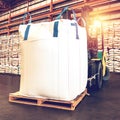 Forklift handling jumbo sugar bag for stuffing into container for export. Distribution, Logistics Import Export. Royalty Free Stock Photo
